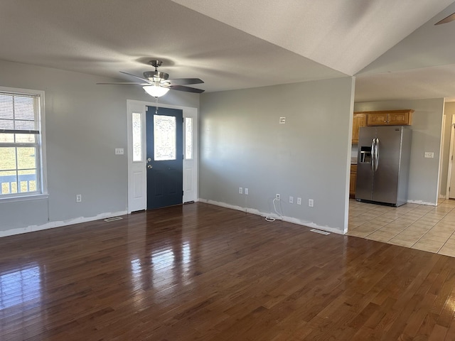 entryway featuring ceiling fan, lofted ceiling, and light wood-type flooring