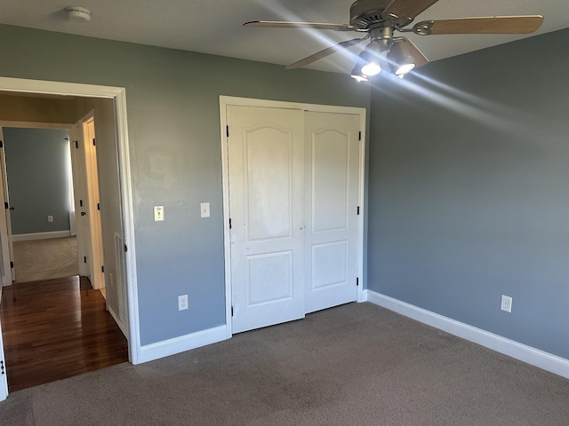 unfurnished bedroom featuring carpet floors, ceiling fan, and a closet