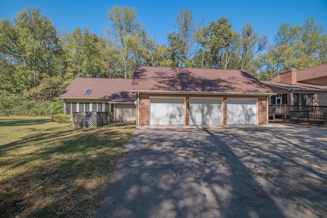 view of front of house featuring a garage and a front lawn