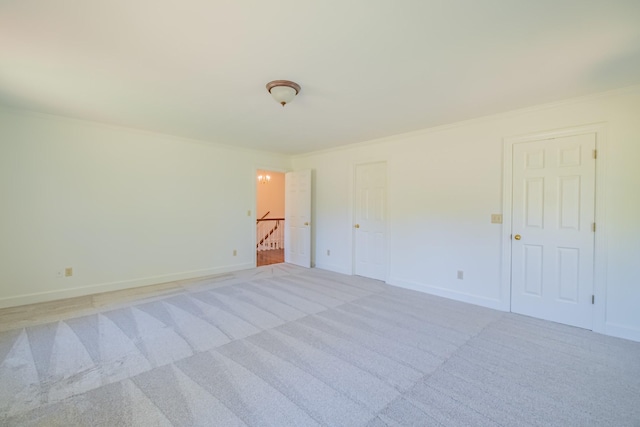 carpeted spare room with ornamental molding