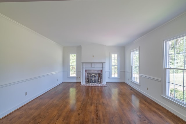 unfurnished living room featuring dark hardwood / wood-style flooring, a fireplace, and ornamental molding