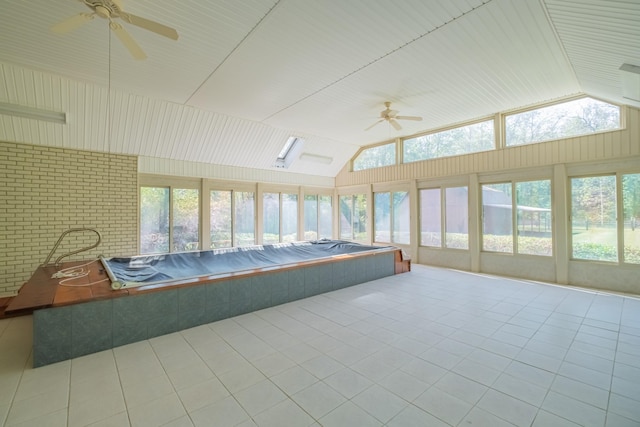 unfurnished sunroom featuring ceiling fan, lofted ceiling, and a jacuzzi