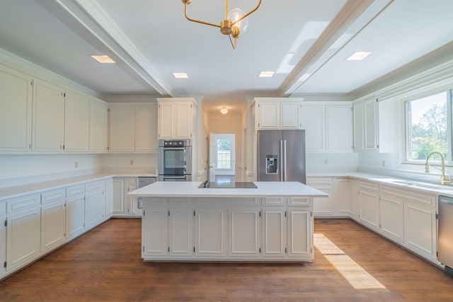 kitchen featuring a kitchen island, appliances with stainless steel finishes, sink, and light hardwood / wood-style floors