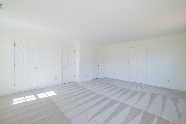 carpeted spare room with ornamental molding