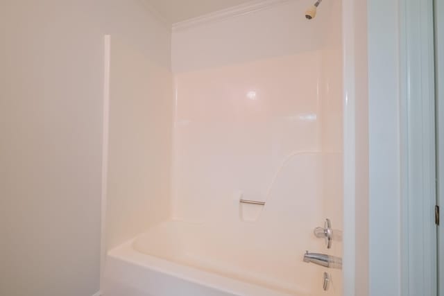 bathroom featuring bathing tub / shower combination and crown molding