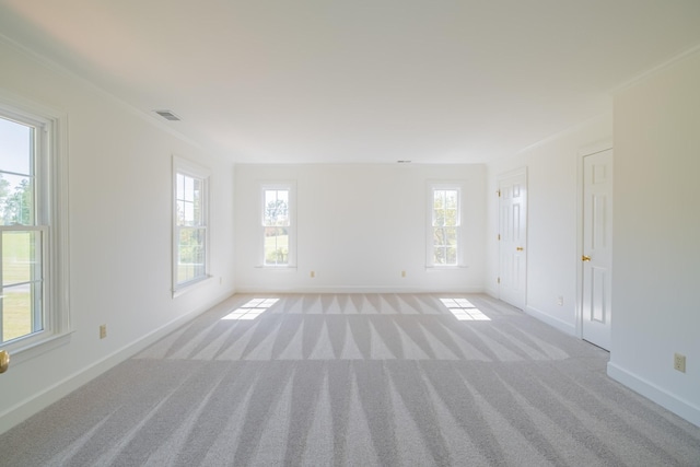 carpeted empty room featuring crown molding