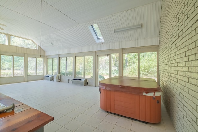 sunroom featuring vaulted ceiling with skylight