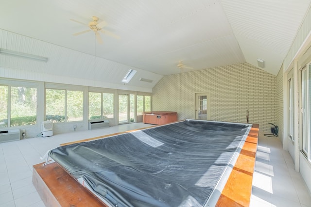 tiled bedroom featuring lofted ceiling, an AC wall unit, ceiling fan, and brick wall