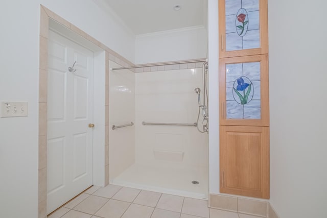 bathroom with tile patterned flooring, crown molding, and walk in shower