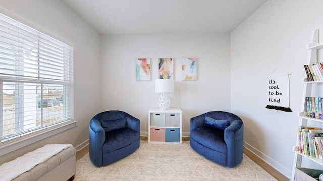 sitting room with a healthy amount of sunlight and baseboards