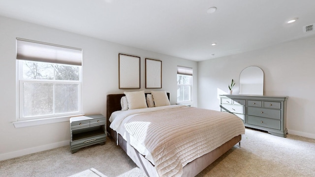 bedroom with light carpet, visible vents, baseboards, and recessed lighting