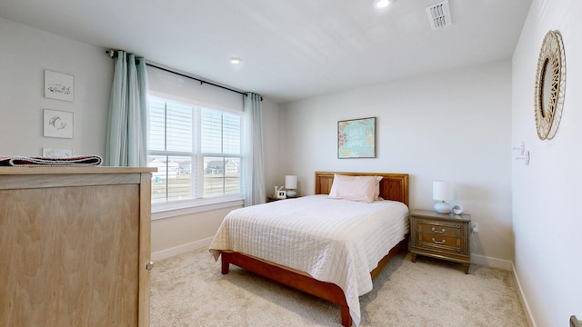 bedroom with carpet, visible vents, and baseboards