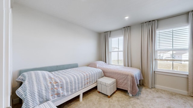 bedroom with carpet floors and baseboards