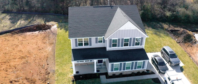 birds eye view of property featuring a wooded view