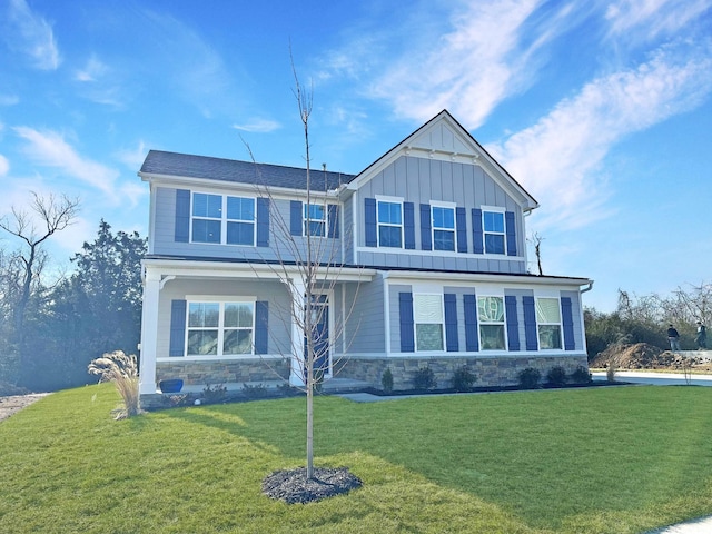 craftsman-style home featuring board and batten siding, stone siding, and a front lawn