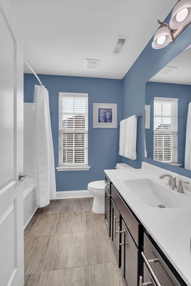 full bathroom featuring vanity, toilet, and shower / tub combo with curtain