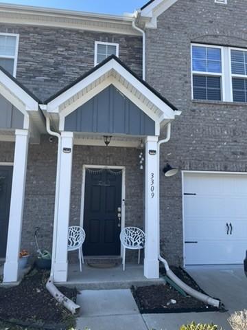 doorway to property featuring a porch and a garage