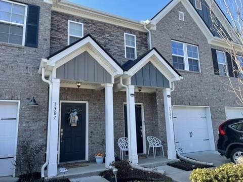 townhome / multi-family property featuring a garage and a porch