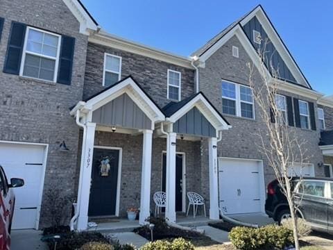 multi unit property featuring a garage and a porch