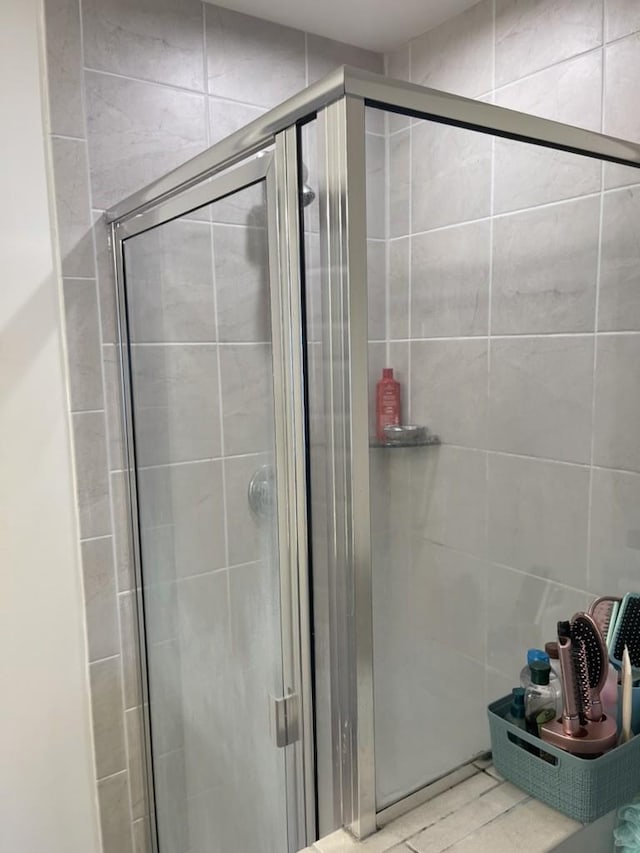 bathroom featuring a shower with door