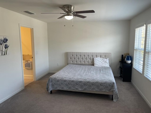 carpeted bedroom featuring ceiling fan and ensuite bath