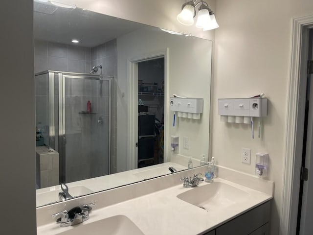 bathroom featuring walk in shower and vanity