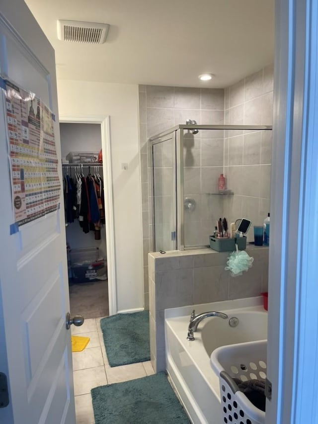 bathroom featuring tile patterned flooring and independent shower and bath