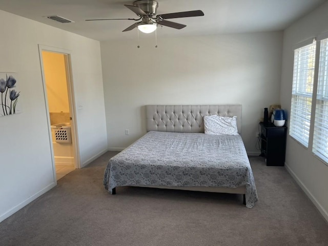 carpeted bedroom with ceiling fan and ensuite bathroom