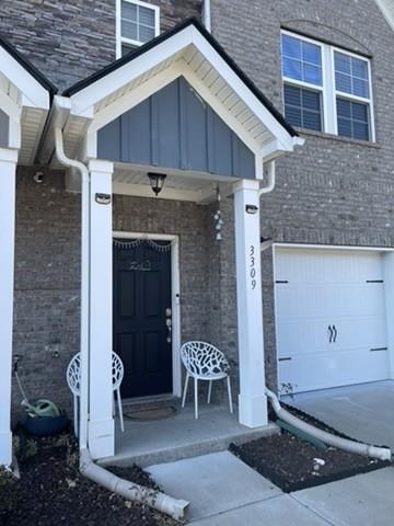 entrance to property with a garage and covered porch