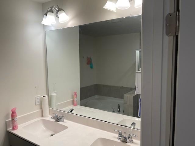 full bath featuring double vanity, a sink, and a bath