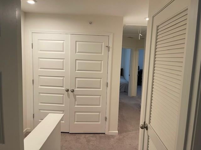 corridor with carpet floors and baseboards