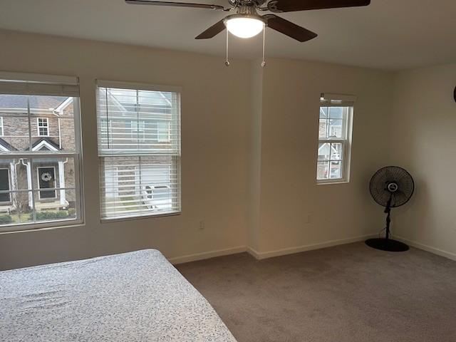 bedroom featuring carpet, baseboards, and ceiling fan