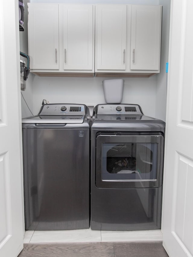 laundry room with cabinets and washer and dryer