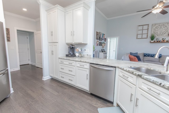 kitchen featuring crown molding, appliances with stainless steel finishes, wood-type flooring, and white cabinets