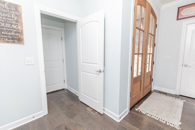 foyer featuring ornamental molding and dark wood-type flooring