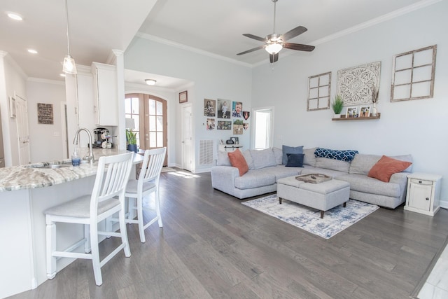 living room featuring ornamental molding, sink, dark hardwood / wood-style flooring, and french doors