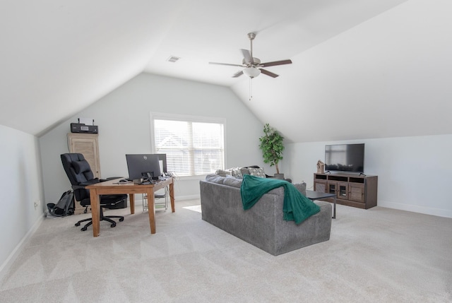 carpeted home office featuring lofted ceiling and ceiling fan