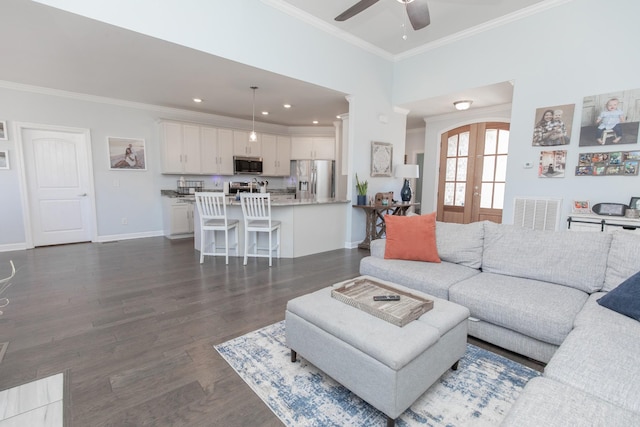 living room featuring ornamental molding, dark wood-type flooring, ceiling fan, and french doors