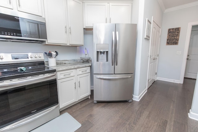 kitchen with dark wood-type flooring, stainless steel appliances, light stone counters, ornamental molding, and white cabinets