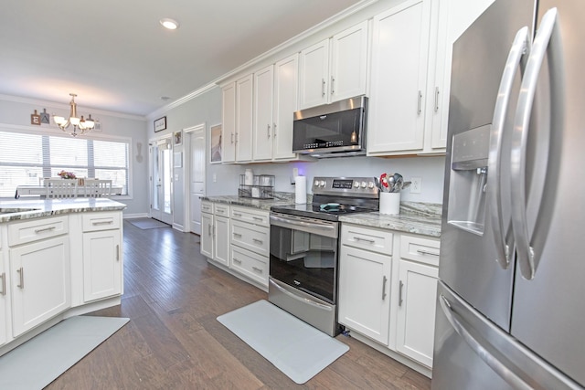 kitchen with pendant lighting, stainless steel appliances, dark hardwood / wood-style floors, light stone countertops, and white cabinets