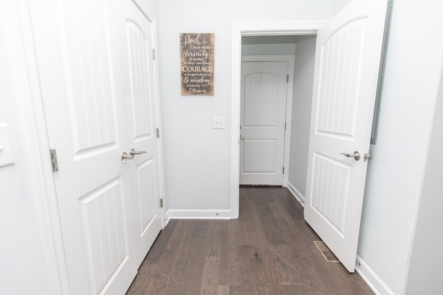 hallway with dark wood-type flooring