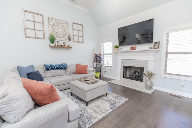 living room featuring a tile fireplace, lofted ceiling, and dark hardwood / wood-style floors