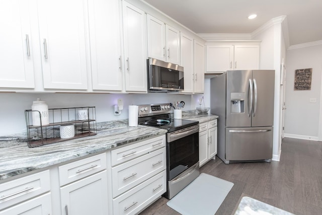 kitchen featuring dark wood-type flooring, white cabinetry, crown molding, appliances with stainless steel finishes, and light stone countertops