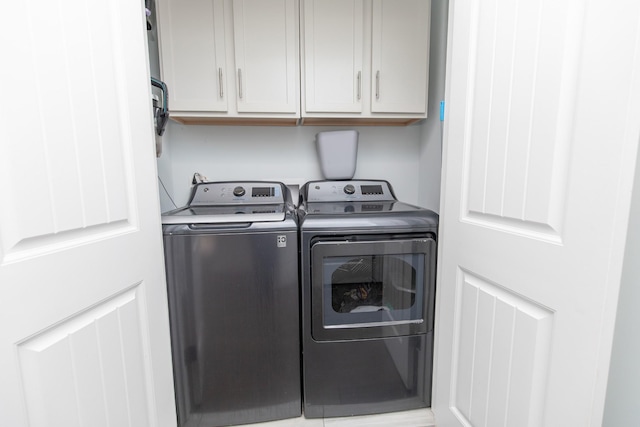 laundry room with cabinets and washing machine and dryer