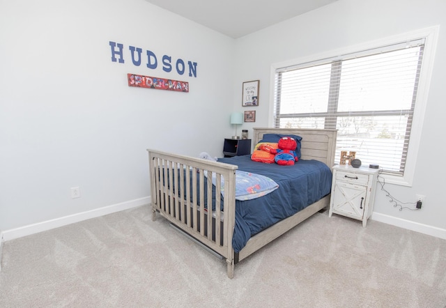 bedroom with light carpet and multiple windows