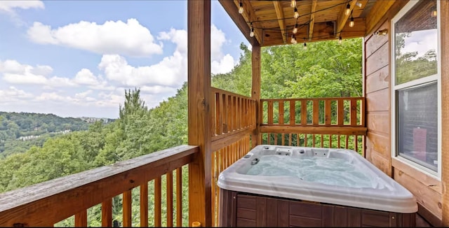 wooden deck with a hot tub