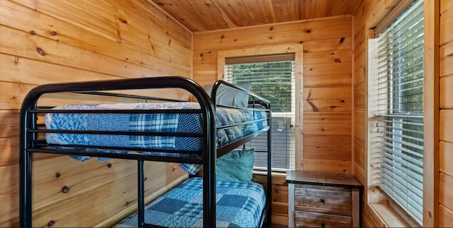 bedroom featuring wood walls and wooden ceiling