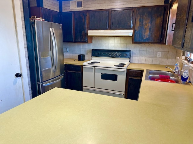 kitchen featuring double oven range, sink, stainless steel fridge with ice dispenser, and dark brown cabinets