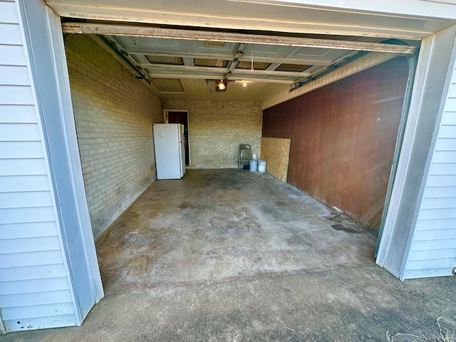 garage featuring a garage door opener and white fridge