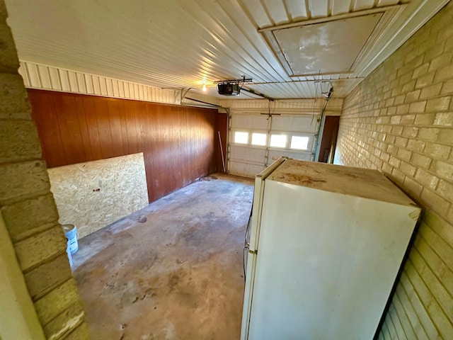 garage featuring a garage door opener and wood walls